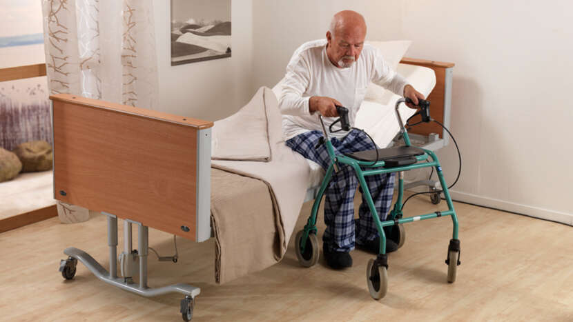 ArjoHuntleigh-Medical-Beds-Minuet-2-Patient-getting-out-of-bed_Product_Page_Main_Image.jpg