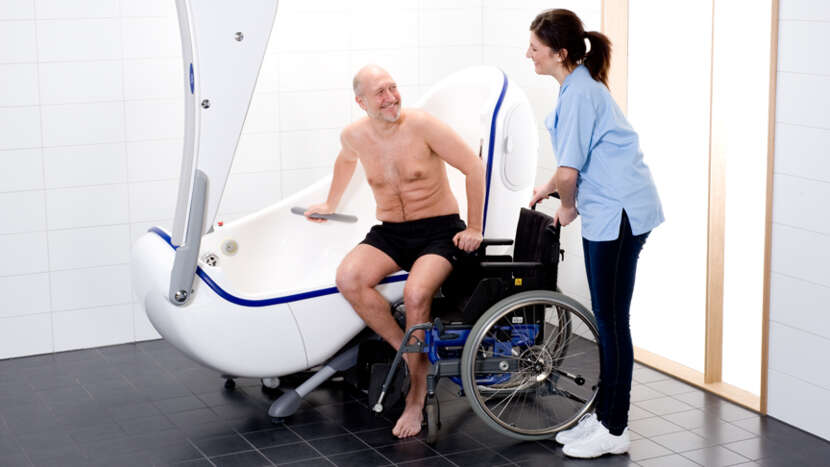 ArjoHuntleigh-Products-Hygiene-Systems-Bathing-Central-Bathing-Area-Parker-Nurse-Male-Patient-transfer-from-wheelchair-to-bath_Product_Page_Main_Image.jpg