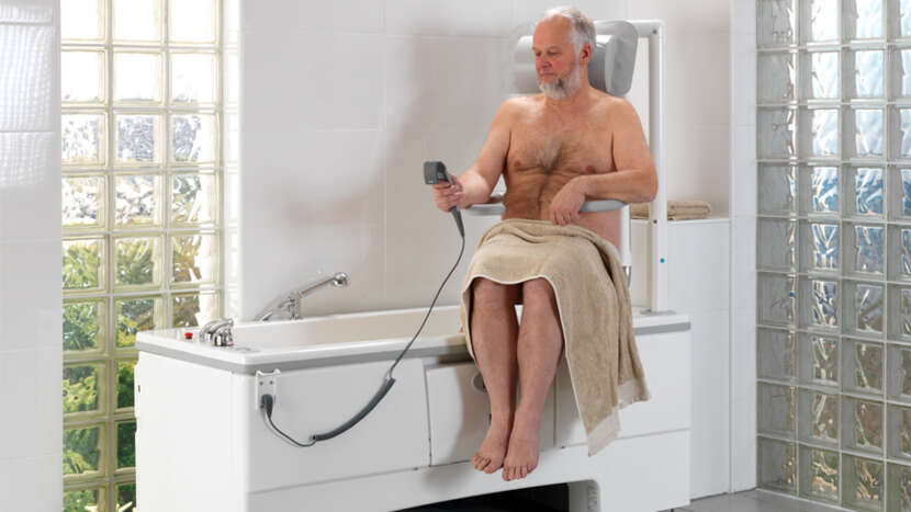 ArjoHuntleigh-Products-Hygiene-Systems-Bathing-Private-Bathing-Area-Malibu-Bath-Male-Patient-using-Chairlift-by-himself_Product_Page_Main_Image.jpg